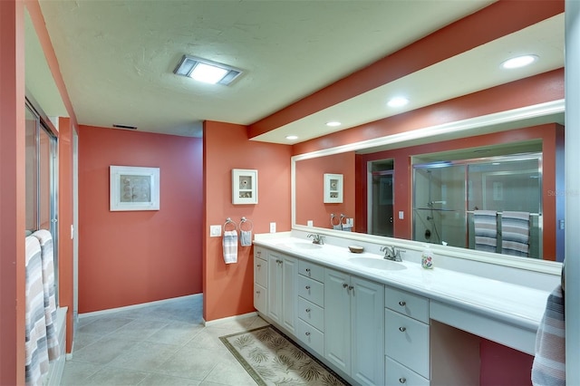 bathroom with vanity, tile patterned floors, and walk in shower