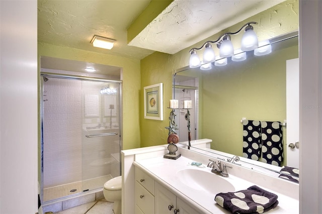 bathroom featuring tile patterned flooring, vanity, toilet, and a shower with door