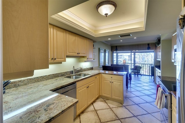 kitchen featuring light brown cabinets, kitchen peninsula, sink, and a tray ceiling