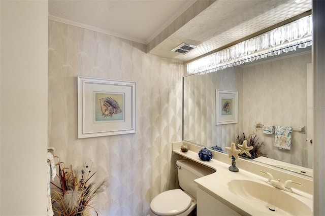 bathroom featuring vanity, toilet, and ornamental molding