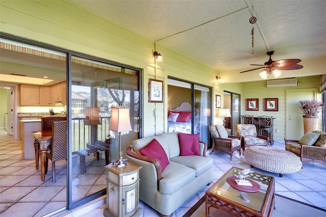 tiled living room with a textured ceiling, a wall unit AC, and ceiling fan