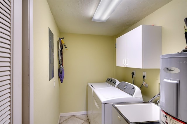 clothes washing area featuring cabinets, separate washer and dryer, electric water heater, a textured ceiling, and light tile patterned floors