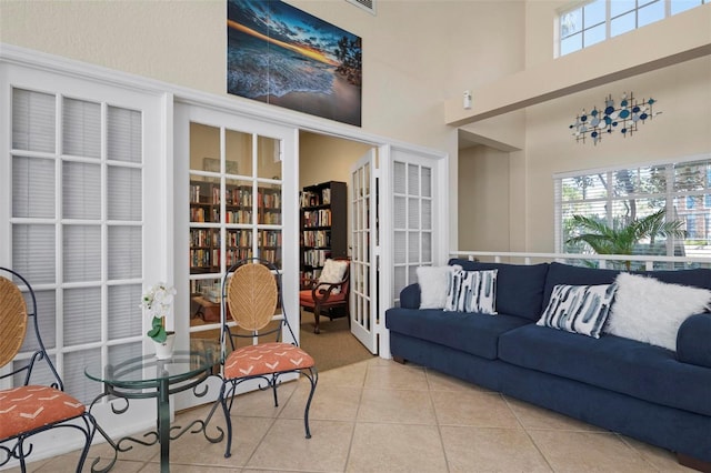 tiled living room with a high ceiling