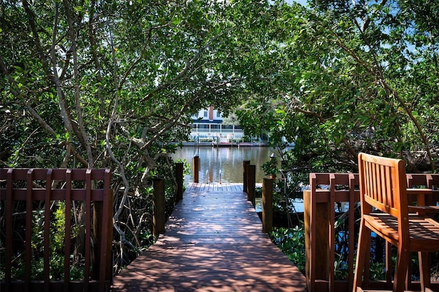 view of property's community featuring a water view and a dock