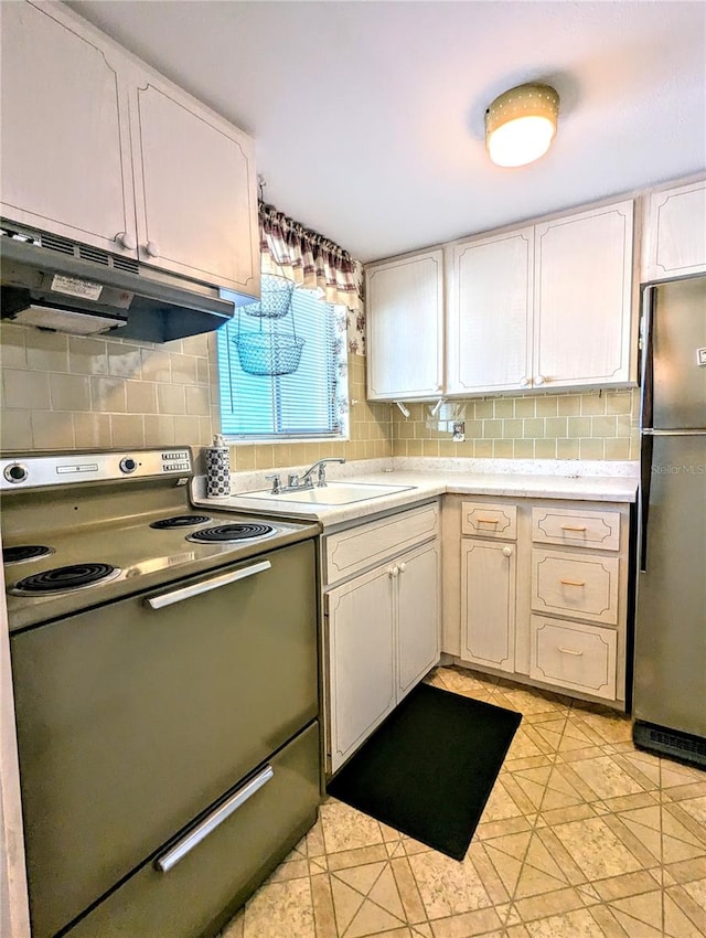 kitchen with range with electric stovetop, backsplash, stainless steel fridge, and white cabinets