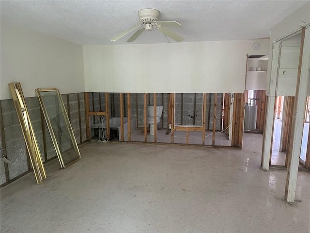 interior space featuring ceiling fan and a textured ceiling