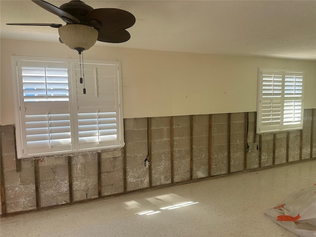 spare room with ceiling fan and a textured ceiling