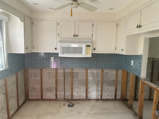 kitchen featuring ceiling fan, white cabinets, and a healthy amount of sunlight