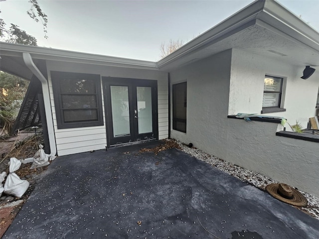 view of exterior entry featuring french doors