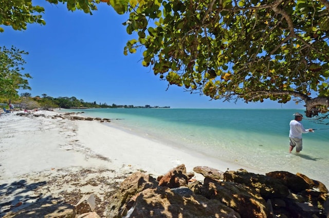 property view of water featuring a beach view