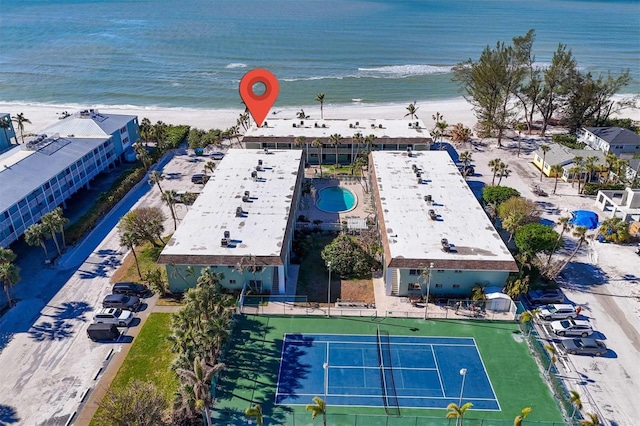 drone / aerial view with a water view and a beach view