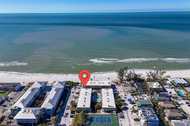 birds eye view of property with a water view and a beach view