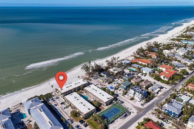 drone / aerial view with a beach view and a water view