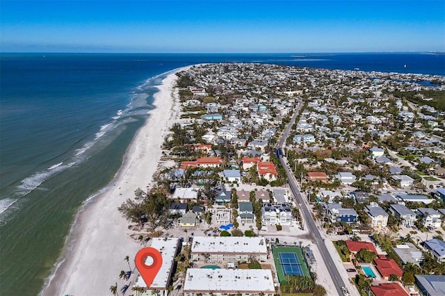 bird's eye view featuring a water view and a beach view