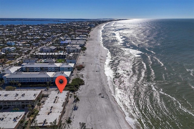 birds eye view of property featuring a beach view and a water view