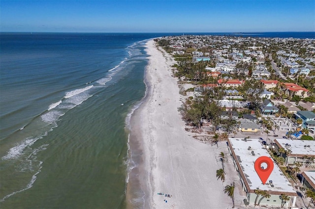 birds eye view of property with a beach view and a water view