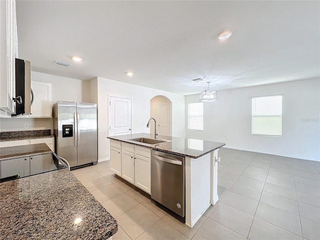 kitchen featuring appliances with stainless steel finishes, an island with sink, a healthy amount of sunlight, and sink