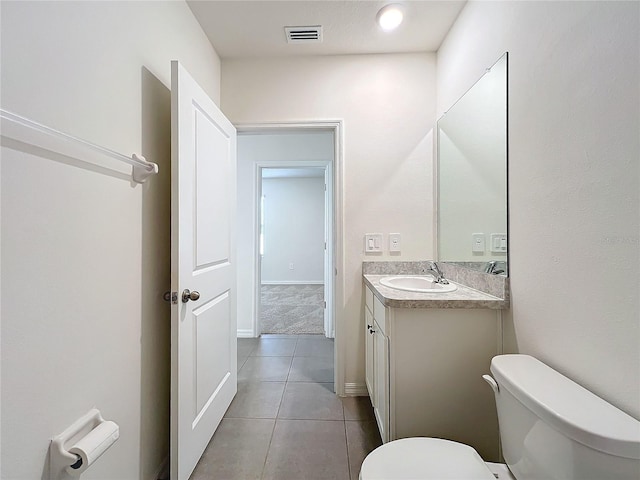 bathroom featuring tile patterned floors, vanity, and toilet