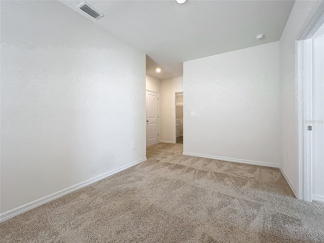 empty room featuring light colored carpet