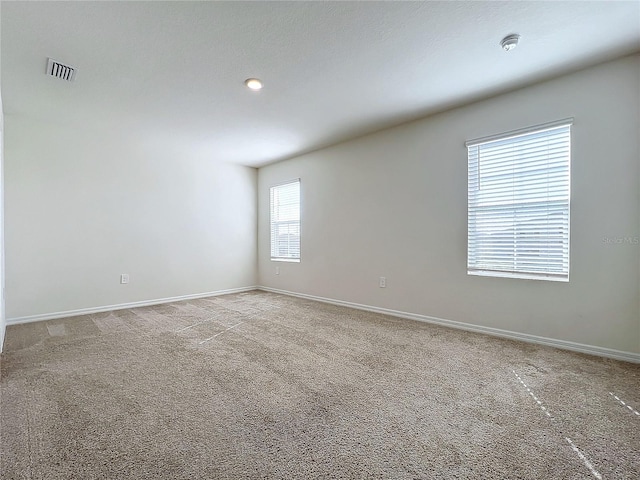 carpeted spare room with a healthy amount of sunlight