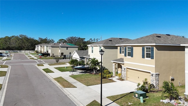 view of front of house featuring a front lawn and a garage