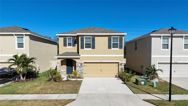 front of property featuring a front yard and a garage