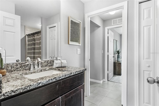 bathroom with a shower with shower curtain, vanity, and tile patterned floors