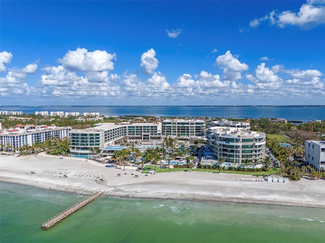 birds eye view of property with a water view and a view of the beach