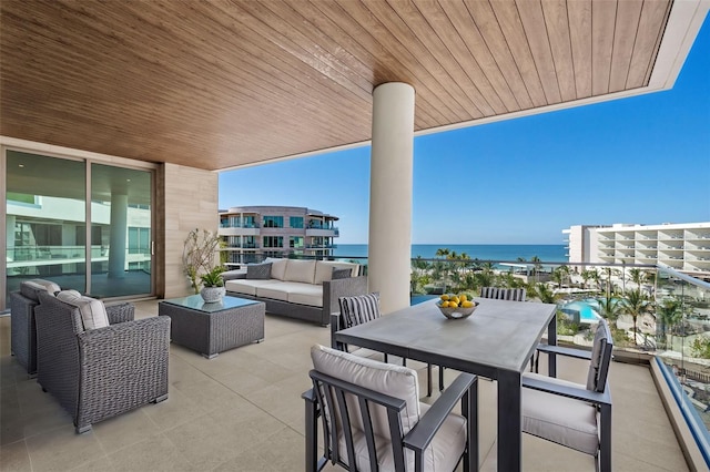 view of patio / terrace featuring outdoor lounge area, a water view, and a balcony