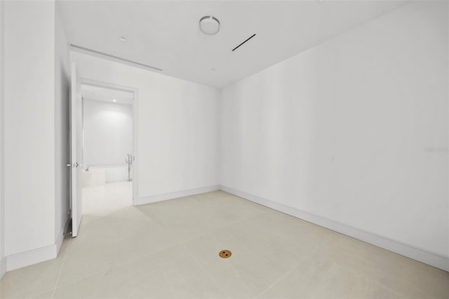 unfurnished room featuring light tile patterned floors