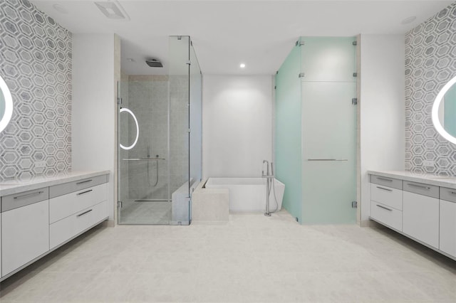 bathroom with shower with separate bathtub, vanity, and tile patterned floors