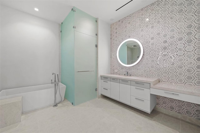 bathroom featuring vanity and a bath