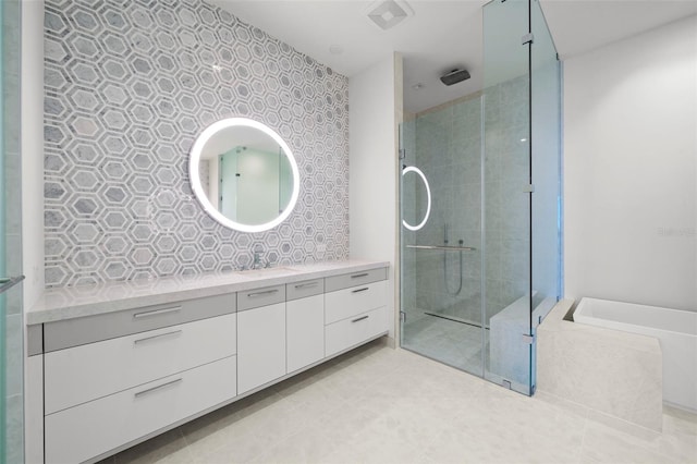 bathroom with vanity and independent shower and bath