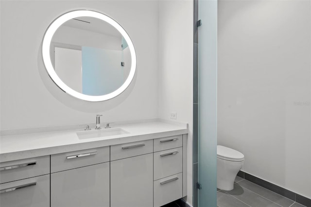 bathroom featuring tile patterned flooring, vanity, and toilet