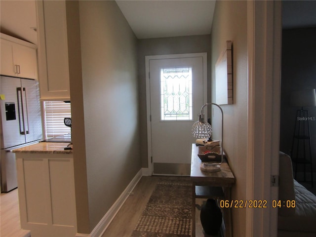 doorway to outside with light hardwood / wood-style floors