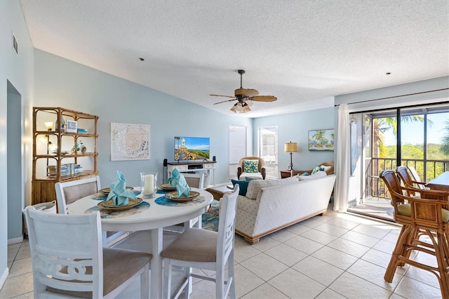 dining room with ceiling fan, light tile patterned floors, and a textured ceiling