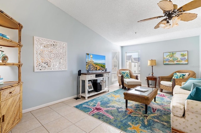 living room featuring a textured ceiling, ceiling fan, lofted ceiling, and light tile patterned flooring