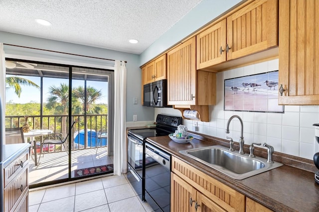 kitchen featuring decorative backsplash, a textured ceiling, sink, black appliances, and light tile patterned floors