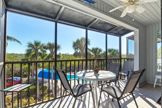 sunroom / solarium featuring ceiling fan