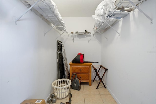 walk in closet with light tile patterned floors