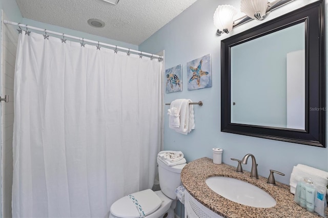 bathroom featuring vanity, toilet, and a textured ceiling