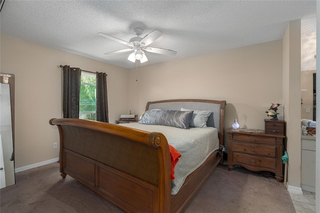 bedroom featuring a textured ceiling, carpet floors, and ceiling fan