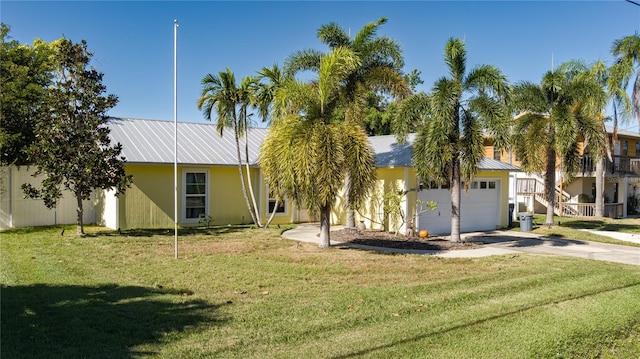 view of front of house featuring a garage and a front lawn