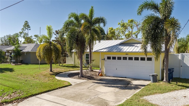 ranch-style home featuring a front lawn and a garage