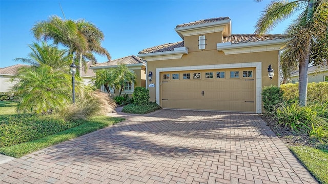 mediterranean / spanish house with a garage