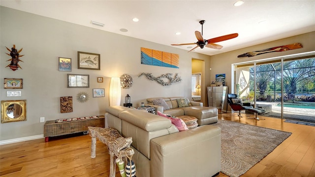 living room with light wood-type flooring and ceiling fan