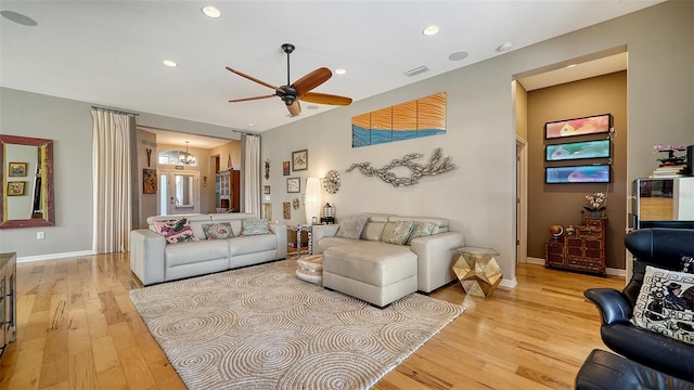 living room featuring light hardwood / wood-style floors and ceiling fan