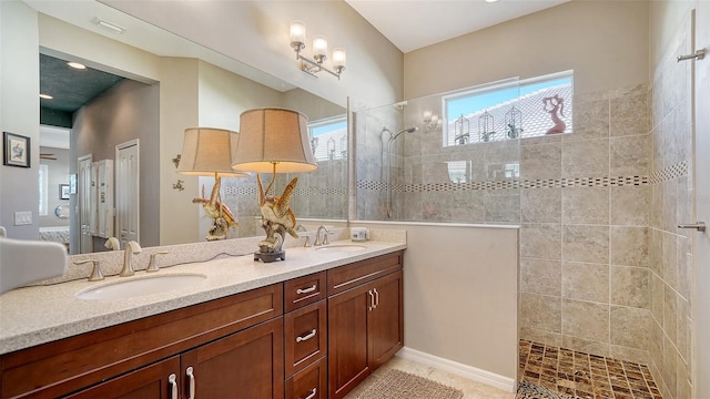 bathroom featuring a tile shower and vanity