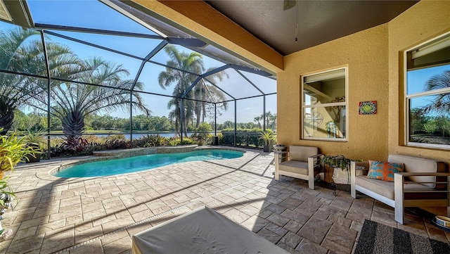 view of swimming pool with glass enclosure and a patio