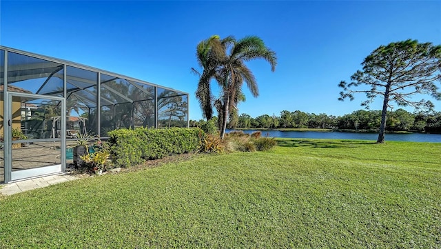 view of yard featuring glass enclosure and a water view